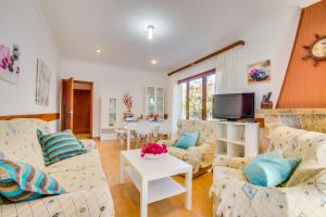 a living room with two couches and a tv at Ideal Property Mallorca - Villa Rosita 12 in Alcudia