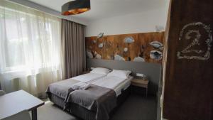 a bedroom with a large bed with a wooden headboard at Family Fewo Sibiu in Sibiu