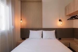 a bedroom with a large bed with white pillows at Summer Feelings in Skala Sotiros