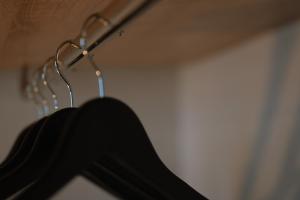 a black shirt hanging on a metal rack at Summer Feelings in Skala Sotiros