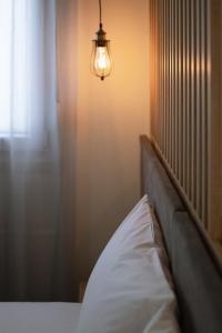 a bedroom with a bed with a light and a window at Summer Feelings in Skala Sotiros