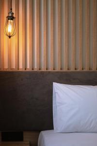 a bed with a white pillow in a room at Summer Feelings in Skala Sotiros