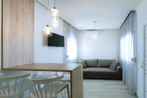 a living room with a dining table and a couch at Summer Feelings in Skala Sotiros