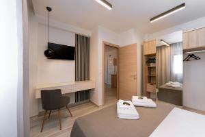a living room with a table and a chair at Summer Feelings in Skala Sotiros