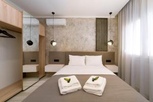 a bedroom with a large bed with towels on it at Summer Feelings in Skala Sotiros