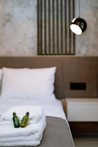 two bottles of beer sitting on top of a bed at Summer Feelings in Skala Sotiros
