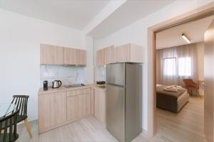 a kitchen with a stainless steel refrigerator in a room at Summer Feelings in Skala Sotiros