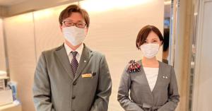 a man and woman wearing masks in a room at Nagoya Fushimi Mont-Blanc Hotel in Nagoya