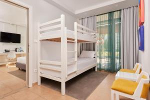 a bedroom with a white bunk bed in a room at Azul Beach Resort Montenegro by Karisma - All Inclusive in Ulcinj