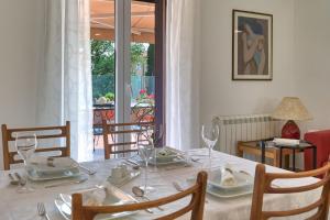 a dining room table with a white table cloth and glasses at Nina in Medulin