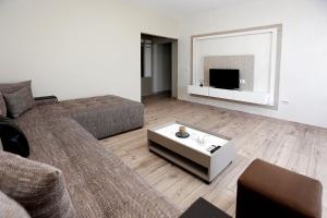 a living room with a couch and a coffee table at Корал, Хотел, Поморие in Pomorie