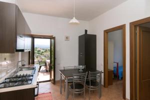 a kitchen with a table and a kitchen with a view at Costiera del Cilento Apartments in Casal Velino