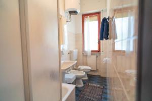 a bathroom with two toilets and a sink and a shower at [PIETRA LIGURE] The apartment for your vacations. in Pietra Ligure