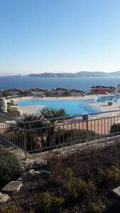 a view of a swimming pool with the ocean in the background at Apartment with a sea view in Skiper resort in Crveni Vrh