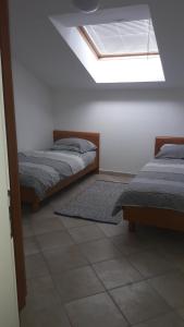 a bedroom with two beds and a skylight at Apartment with a sea view in Skiper resort in Crveni Vrh
