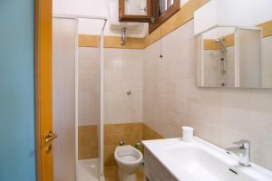 a bathroom with a toilet and a sink and a shower at Costiera del Cilento Apartments in Casal Velino +21 photos