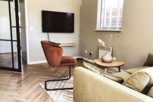 a living room with a couch and a chair at Flierzicht in Lievelde