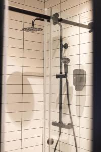 a shower in a bathroom with a glass door at Apartamentos Mk77 León - LaHoz in León