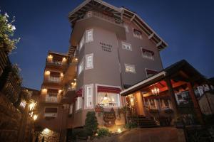 a large building with lights on it at night at Pousada Bella Terra in Gramado