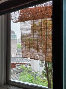 a window with a view of a building at Seochon Guesthouse in Seoul