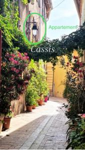 a street with plants and a sign that reads apartment cassis at Appartement le Quai du Port Cassis parking clim in Cassis