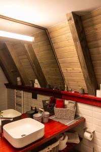 a bathroom with a toilet and a sink on a counter at Hai La Munte Bran in Bran +34 photos