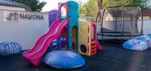 a playground with a slide and a swing at Vila Navona in Saturn