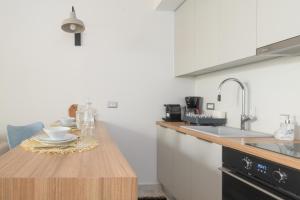 a kitchen with a wooden counter top and a sink at Pilos Sunrise Loft in Pylos