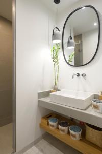 a bathroom with a sink and a mirror at Pilos Sunrise Loft in Pylos