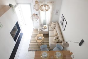a living room with a couch and a table at Pilos Sunrise Loft in Pylos