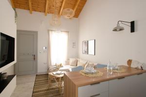 a living room with a couch and a table at Pilos Sunrise Loft in Pylos