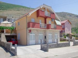 a house with a car parked in front of it at Apartment Ana-Marija in Trebinje