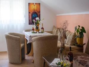 a living room with a table with flowers on it at Apartment Ana-Marija in Trebinje