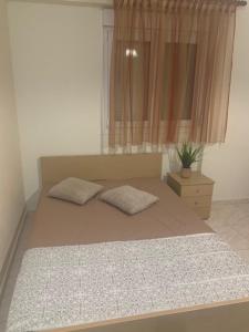 a bedroom with a bed with two pillows on it at Elin Loft Rooms in Flogita +2 photos