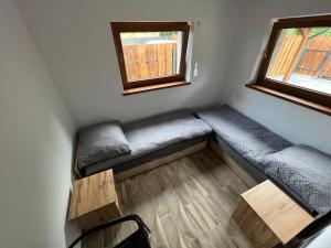 a small room with two beds and a window at Domek-Radawa-Królewska 77,domek Piotr in Radawa