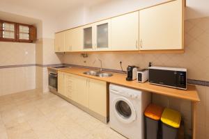 a kitchen with a sink and a washing machine at FLH Alfama Flat with River View in Lisbon