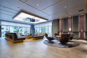 a lobby with a salon with chairs and a table at Via Inn Hakataguchi Ekimae in Fukuoka