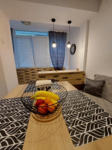 a bowl of fruit on a table in a bedroom at Apartment Jasmin in Tsarevo
