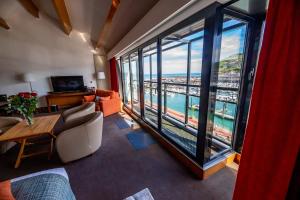 a living room with a view of the ocean at Hotel Le Grand Pavois in Fécamp