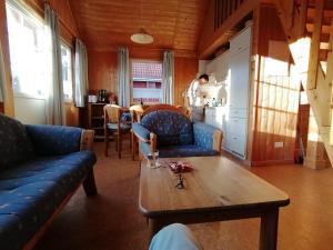 a living room with blue couches and a wooden table at Casita in Userin