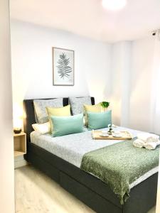 a bedroom with a bed with blue and yellow pillows at Nuevo Apto B Centrico Garaje Incluido in Castro-Urdiales
