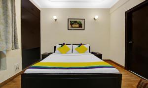 a bedroom with a large bed with a colorful blanket at Itsy By Treebo - Arien International in New Delhi