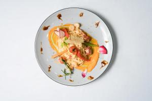 a plate of food on a white table at Azul Beach Resort Montenegro by Karisma - All Inclusive in Ulcinj