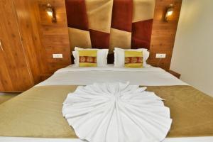 a bed with a white umbrella on top of it at Hotel sallow International-Hotel Near Golden Temple in Amritsar +3 photos