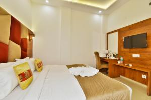 a bedroom with a bed and a desk and a television at Hotel sallow International-Hotel Near Golden Temple in Amritsar