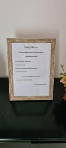 a picture of a menu in a wooden picture frame at Ja-Elas French Touch in Ja-Ela