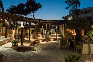 a restaurant with tables and chairs and lights at Azul Beach Resort Montenegro by Karisma - All Inclusive in Ulcinj