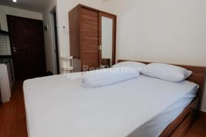 Ένα ή περισσότερα κρεβάτια σε δωμάτιο στο Redliving Apartemen Sayana - Hazelnut Property Tower Cha +34 φωτογραφίες
