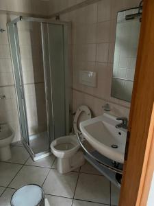 a bathroom with a shower and a toilet and a sink at SALENTO - Casa vacanza - Torre dell’orso in Torre dell'Orso +20 photos
