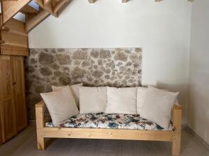 a wooden bench with pillows in a room at Anastasia’s Apartment in Sinarádes